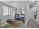 Living room with grey floors, comfortable seating, and views into adjacent rooms and hallway at 825 Great Sky Ct, North Las Vegas, NV 89084