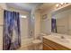 Bathroom featuring a shower-tub combo with a lunar themed shower curtain and a vanity with sink at 9070 Spring Mountain Rd # 113, Las Vegas, NV 89117