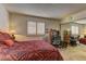 Spacious bedroom with a patterned bedspread, carpet flooring, and large mirror closet doors at 9070 Spring Mountain Rd # 113, Las Vegas, NV 89117