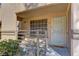 Close-up of the front entrance, featuring a security screen door and view of the patio seating at 9070 Spring Mountain Rd # 113, Las Vegas, NV 89117