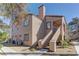 Lovely two-story condo featuring a beige exterior with a red tile roof and well-maintained landscaping at 9070 Spring Mountain Rd # 113, Las Vegas, NV 89117