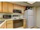 Functional kitchen featuring essential appliances and overhead cabinets for storage at 9070 Spring Mountain Rd # 113, Las Vegas, NV 89117