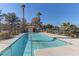 Community pool surrounded by lush landscaping, with a clear blue sky above at 9070 Spring Mountain Rd # 113, Las Vegas, NV 89117