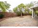 Private backyard with gravel and a patio is bordered by a brick wall at 10127 Capistrello Ave, Las Vegas, NV 89147