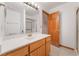 Bathroom vanity with white countertop, a mirror and a shower room at 1044 Geranium Dr, Henderson, NV 89011