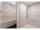 Bathroom featuring a walk-in shower, soaking tub, and marble-style tile walls at 1044 Geranium Dr, Henderson, NV 89011