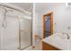 Bathroom with a shower, sink, and toilet with wooden finishes at 1044 Geranium Dr, Henderson, NV 89011