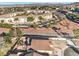 An aerial view of the home and neighborhood featuring mature landscaping, a community park, and mountain views at 1056 Flatfoot Ave, Henderson, NV 89012