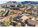An aerial view of the home and neighborhood featuring mature landscaping, community parks, and beautiful mountain views at 1056 Flatfoot Ave, Henderson, NV 89012