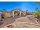 Backyard featuring a large partially-covered patio area, decorative rock, storage shed, and mature landscaping at 1056 Flatfoot Ave, Henderson, NV 89012