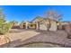 Backyard featuring a large partially-covered patio area, decorative rock, mature landscaping, and mountain views at 1056 Flatfoot Ave, Henderson, NV 89012
