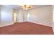 The spacious bedroom has carpet, a ceiling fan, and multiple doorways at 1056 Flatfoot Ave, Henderson, NV 89012