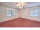 Spacious bedroom with carpet, ceiling fan, and large windows that allow plenty of natural light at 1056 Flatfoot Ave, Henderson, NV 89012