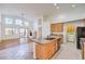 Open-concept kitchen showcases an island with a granite countertop, tile flooring, and flows seamlessly into the living area at 1056 Flatfoot Ave, Henderson, NV 89012