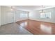 Expansive living room with hardwood floors, bright windows, and stylish light fixtures at 1056 Flatfoot Ave, Henderson, NV 89012