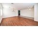 Large living room with a mix of hardwood and tiled floors, bright windows, and modern lighting at 1056 Flatfoot Ave, Henderson, NV 89012