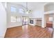 Living room featuring wood floors, a fireplace, and large windows that fill the space with natural light at 1056 Flatfoot Ave, Henderson, NV 89012