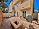 Enclosed backyard featuring stone pavers and a fire pit with block seating at 10840 Holmfield St, Henderson, NV 89052