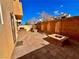 Enclosed backyard featuring stone pavers and a fire pit with block seating at 10840 Holmfield St, Henderson, NV 89052