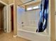 Modern bathroom with a tub-shower combo and blue patterned shower curtain at 10840 Holmfield St, Henderson, NV 89052
