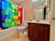 Bathroom with vibrant shower curtain, tile floor, and single sink vanity at 10840 Holmfield St, Henderson, NV 89052