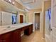 Spacious bathroom featuring dual sinks, a shower-tub combo, and tile flooring at 10840 Holmfield St, Henderson, NV 89052