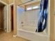 Modern bathroom with a tub-shower combo and blue patterned shower curtain at 10840 Holmfield St, Henderson, NV 89052