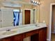 Bathroom with dual sinks, framed mirror and a shower-tub combination at 10840 Holmfield St, Henderson, NV 89052