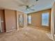 Spacious carpeted bedroom featuring neutral walls and a ceiling fan for added comfort at 10840 Holmfield St, Henderson, NV 89052