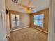 Cozy bedroom with neutral paint, carpet, standard ceiling fan and shuttered windows at 10840 Holmfield St, Henderson, NV 89052