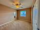 Cozy bedroom with a ceiling fan and window offering natural light at 10840 Holmfield St, Henderson, NV 89052