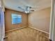 Neutral bedroom featuring carpet, a window with blinds, and a ceiling fan with light at 10840 Holmfield St, Henderson, NV 89052