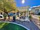 Community space featuring a pergola-covered picnic area with stone seating, surrounded by lush greenery at 10840 Holmfield St, Henderson, NV 89052