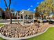 Inviting community space featuring a shaded picnic area surrounded by rock landscaping and manicured lawn at 10840 Holmfield St, Henderson, NV 89052