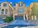 Inviting two-story townhome featuring a spacious two-car garage and neat front yard landscaping at 10840 Holmfield St, Henderson, NV 89052