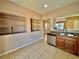 An open kitchen with a breakfast bar, tiled floor, and stainless steel appliances at 10840 Holmfield St, Henderson, NV 89052