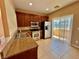 A kitchen with stainless steel appliances, granite countertops, and a sliding glass door to the patio at 10840 Holmfield St, Henderson, NV 89052