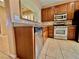Modern kitchen featuring stainless steel appliances, tiled floors, and shaker style cabinets at 10840 Holmfield St, Henderson, NV 89052