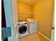 Laundry room with newer washer and dryer, tile floor, and wire shelving at 10840 Holmfield St, Henderson, NV 89052