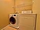 Laundry room with newer washer and dryer, tile floor, and wire shelving at 10840 Holmfield St, Henderson, NV 89052