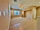 Spacious living room with carpet, ceiling fan, natural light, and staircase to a upper level at 10840 Holmfield St, Henderson, NV 89052