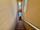 Carpeted staircase with light walls and handrail, leading to upper level at 10840 Holmfield St, Henderson, NV 89052