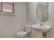 Clean bathroom with pedestal sink, toilet and shower at 11220 Robin Park Ave, Las Vegas, NV 89138