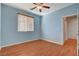 Light blue bedroom with wood flooring and ceiling fan at 11220 Robin Park Ave, Las Vegas, NV 89138