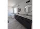Modern bathroom features a double vanity with black fixtures and a standalone bathtub at 121 Comstock St, Pahrump, NV 89048