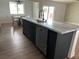 Kitchen island with marble countertops, under-mount sink, stainless steel dishwasher, and an open dining space nearby at 121 Comstock St, Pahrump, NV 89048