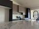 Stylish kitchen featuring marble countertops, stainless steel appliances, designer backsplash, and modern cabinetry, adjacent to dining area at 121 Comstock St, Pahrump, NV 89048