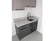 Laundry room featuring gray cabinets with black hardware and marble countertop at 121 Comstock St, Pahrump, NV 89048