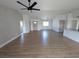 Bright, open-concept living space featuring modern ceiling fan and stylish wood-look flooring throughout the home at 121 Comstock St, Pahrump, NV 89048