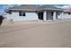 Rear exterior showing covered patio and ample space ready for landscaping at 121 Comstock St, Pahrump, NV 89048